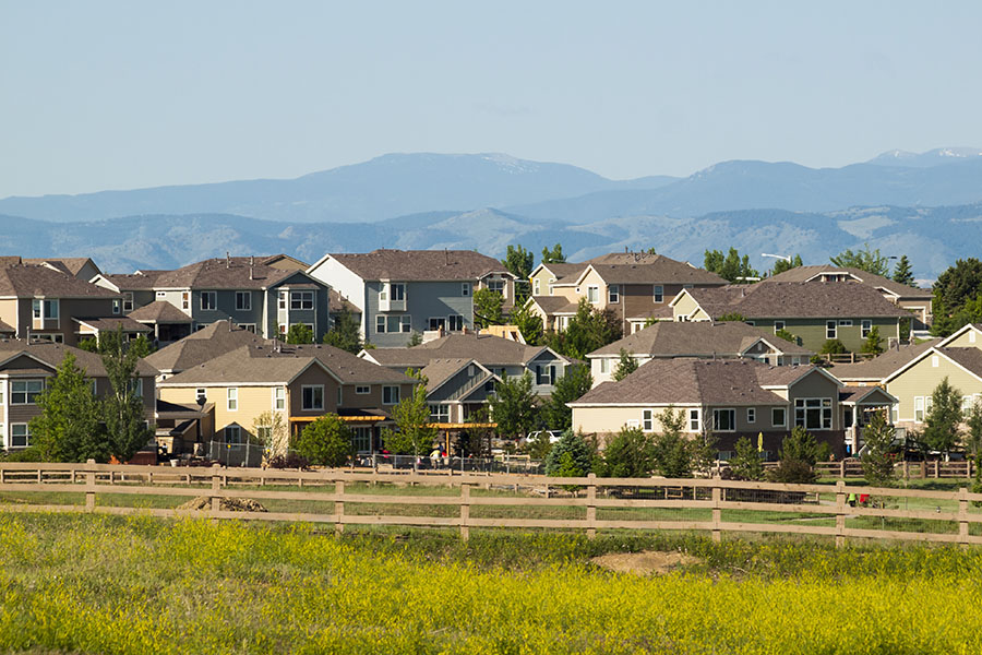 Centennial CO - View of Luxury Homes Surrounded by Wooden Fence in Centennial Colorado with Views of Mountains in the Background